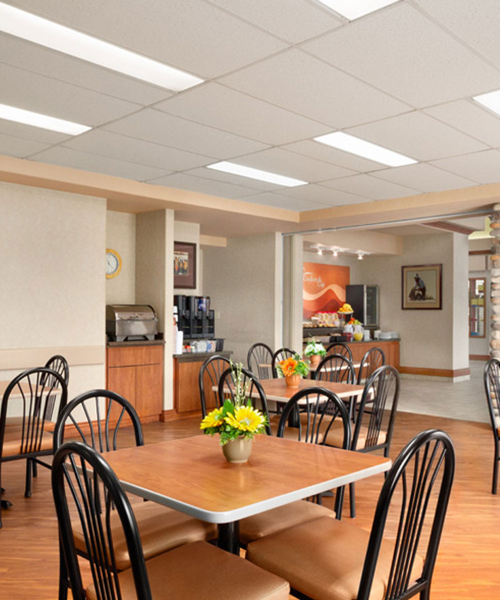 Chairs and tables are placed by the coffee and tea service nook at the Daybreak Café in Days Inn Red Deer.